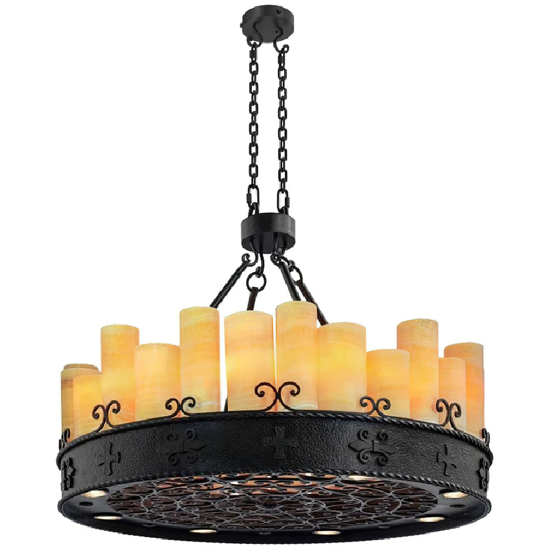 Iron Mesa Onyx Crown Chandelier featuring illuminated natural onyx cylinder shades, handcrafted black iron ring frame, decorative scrollwork, and warm ambient lighting for luxury western interiors.